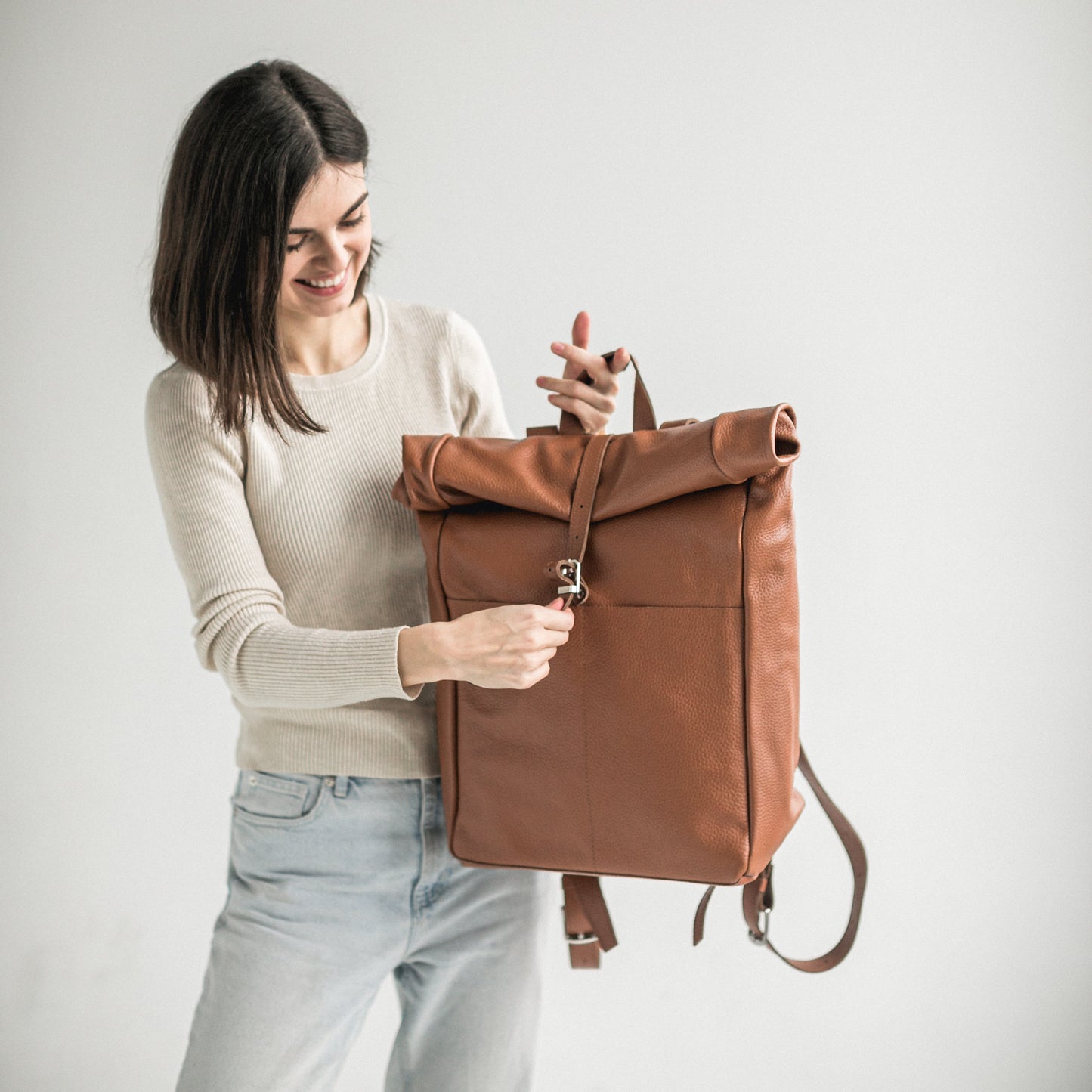 Brown pebbled leather roll-top backpack