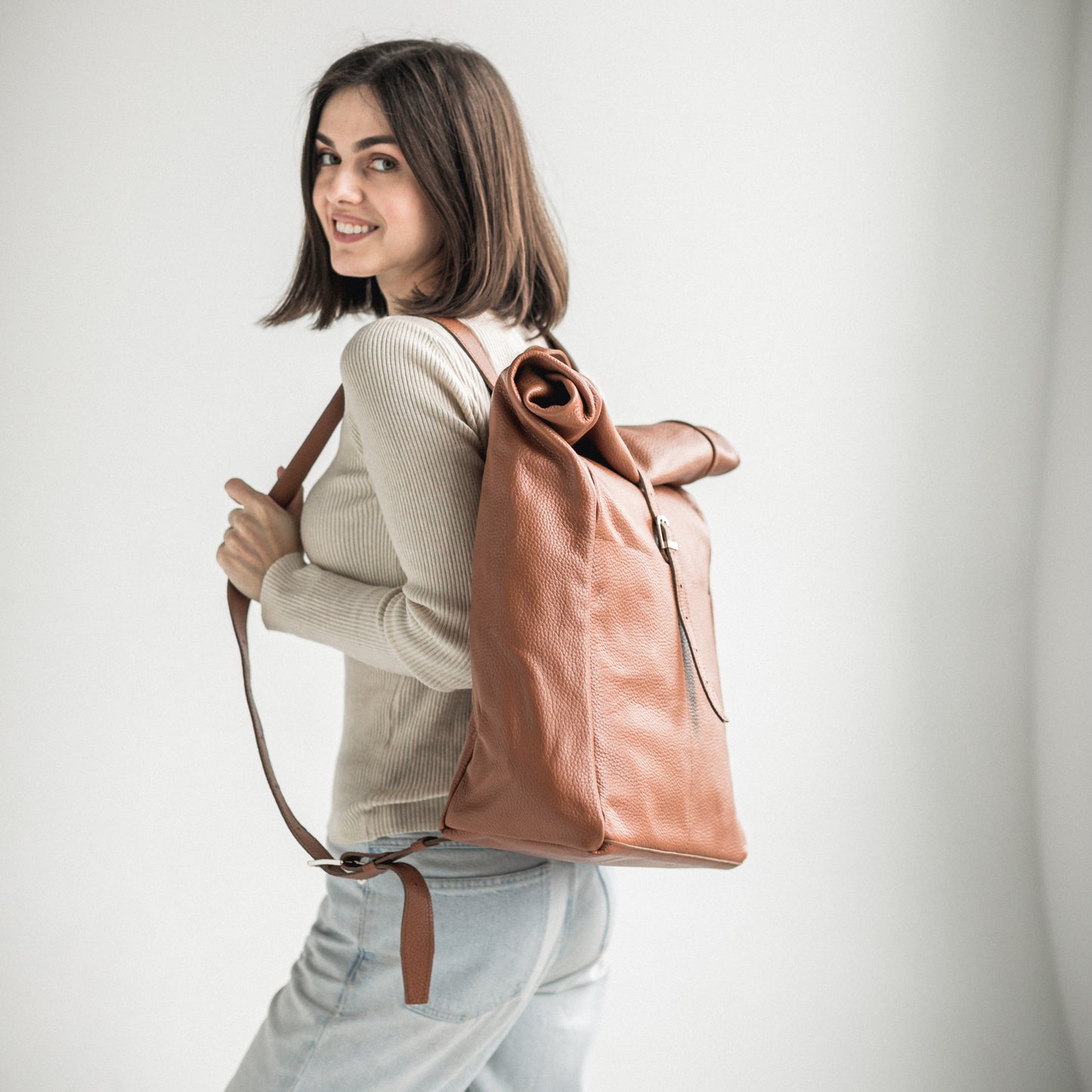 Brown pebbled leather roll-top backpack