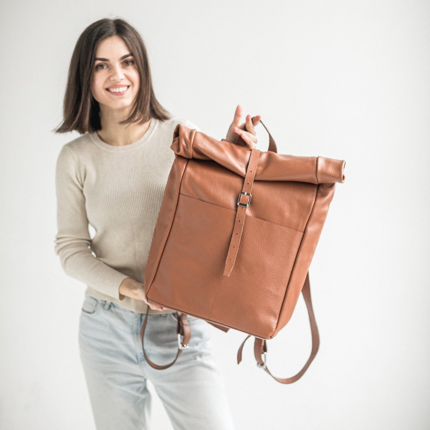 Brown pebbled leather roll-top backpack