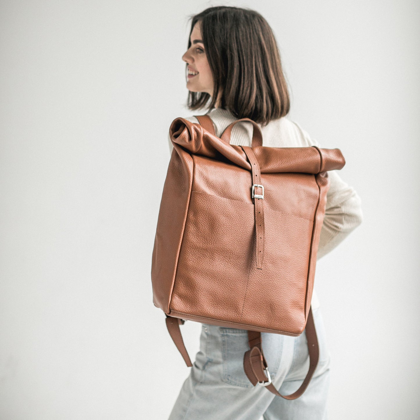 Brown pebbled leather roll-top backpack