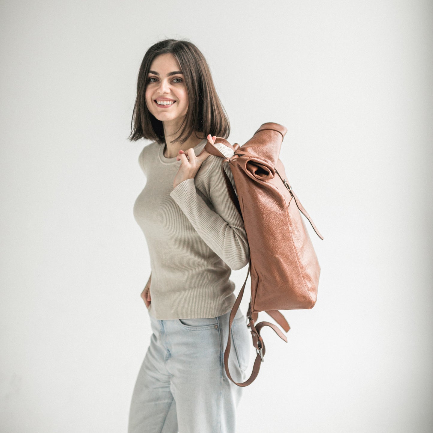 Brown pebbled leather roll-top backpack