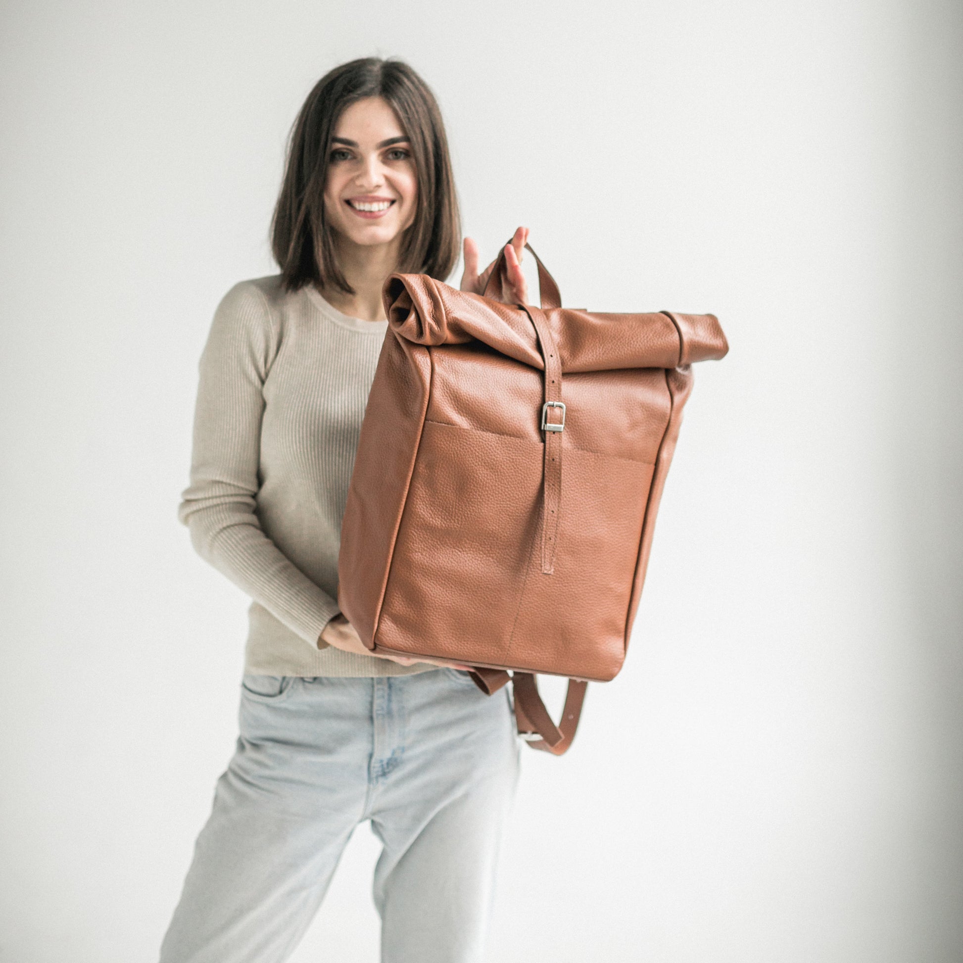 Brown pebbled leather roll-top backpack Brass