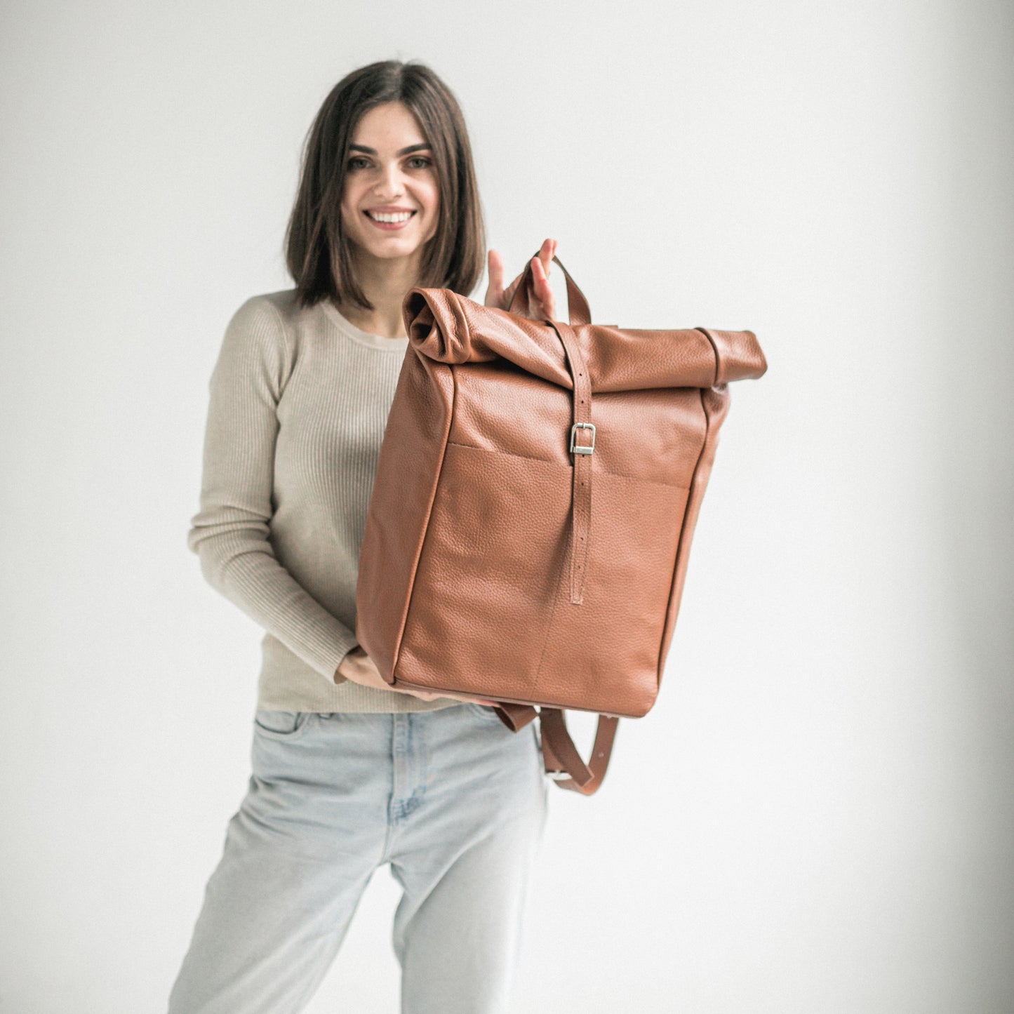 Brown pebbled leather roll-top backpack
