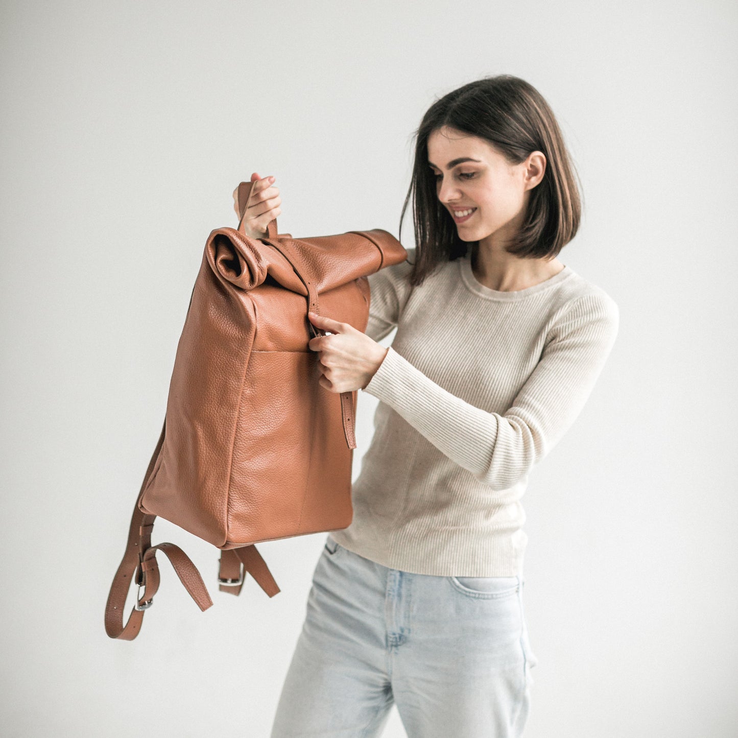 Brown pebbled leather roll-top backpack