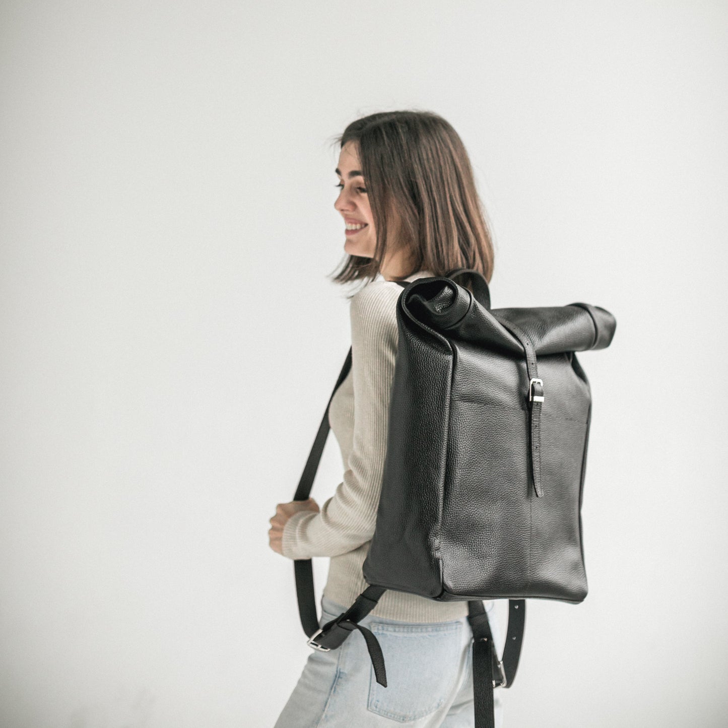 Black pebbled leather roll-top backpack