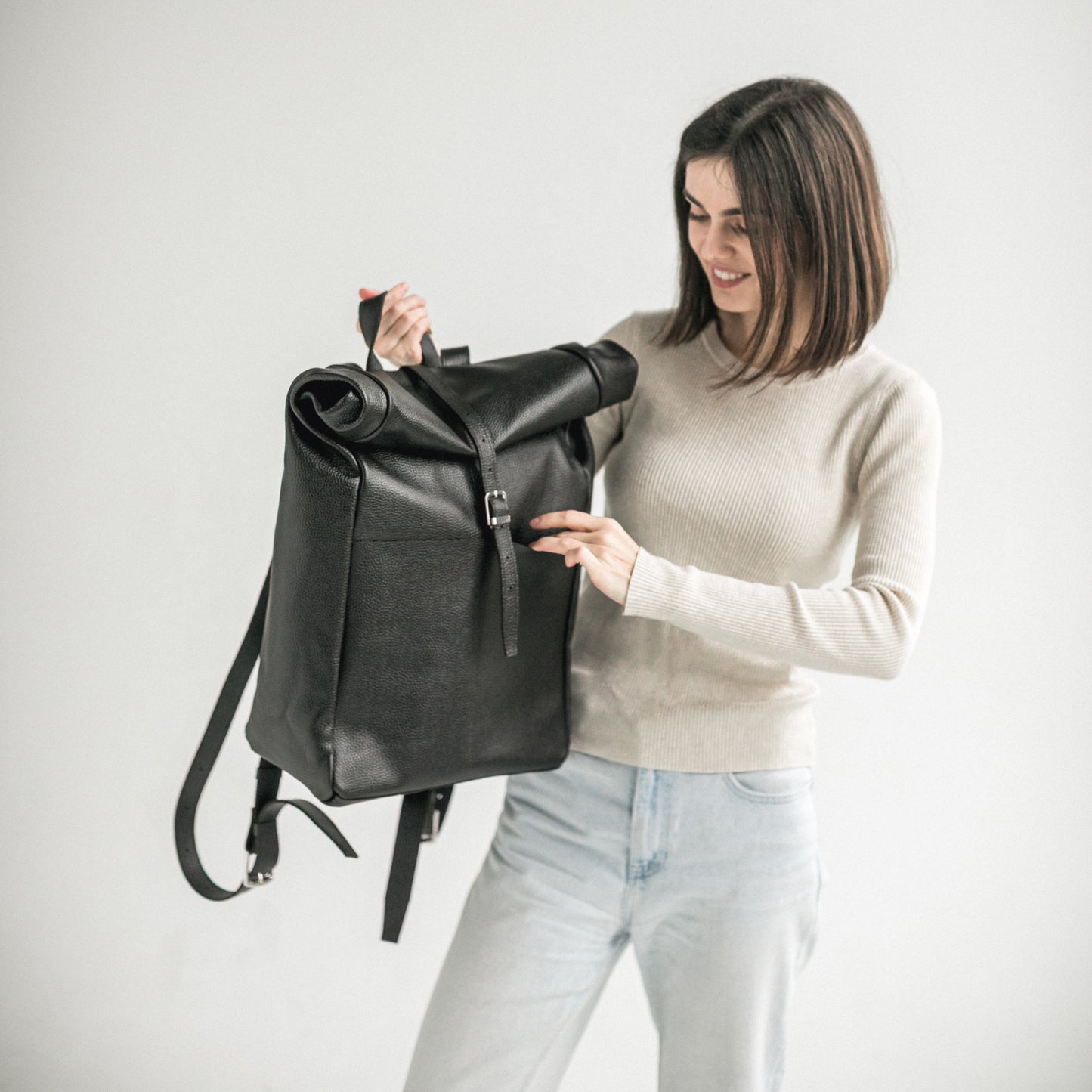 Black pebbled leather roll-top backpack