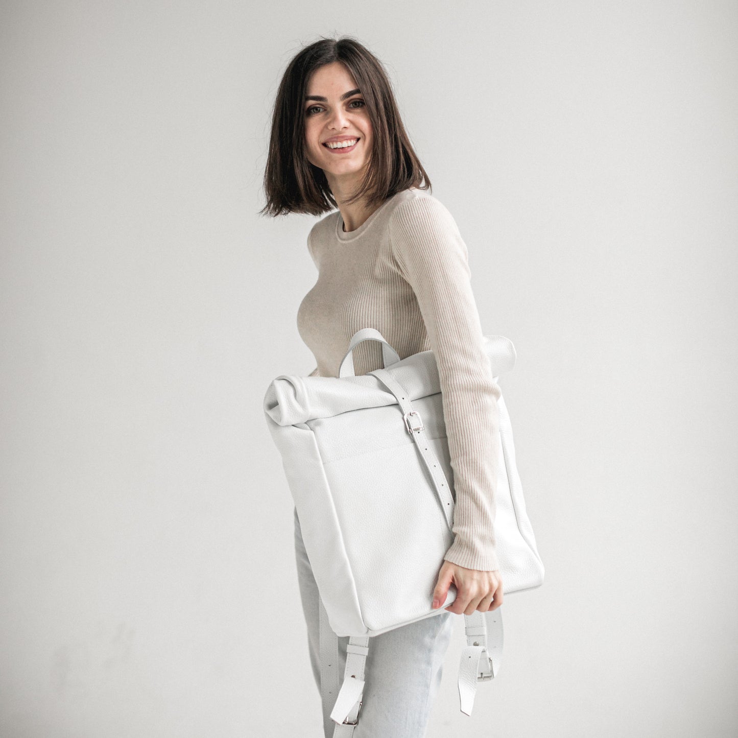 White pebbled leather roll-top backpack