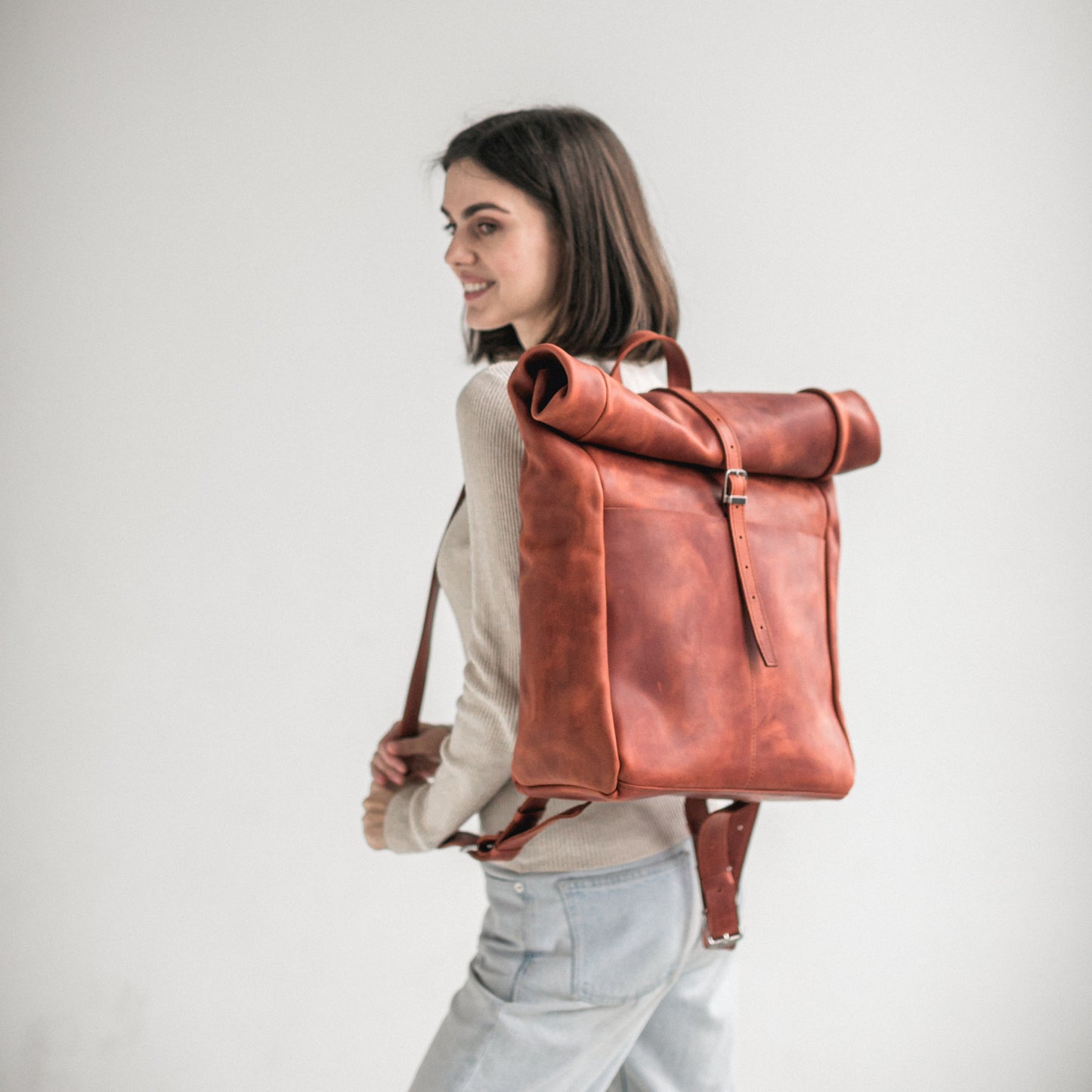 Cognac leather roll-top backpack