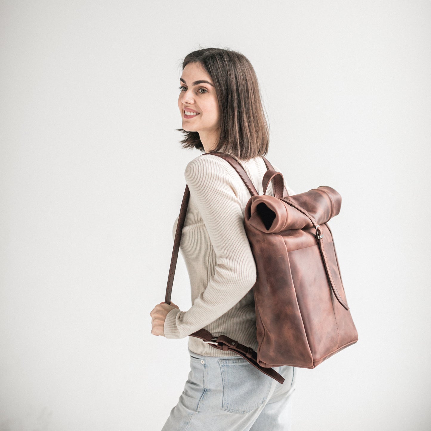 Whiskey brown leather roll-top backpack