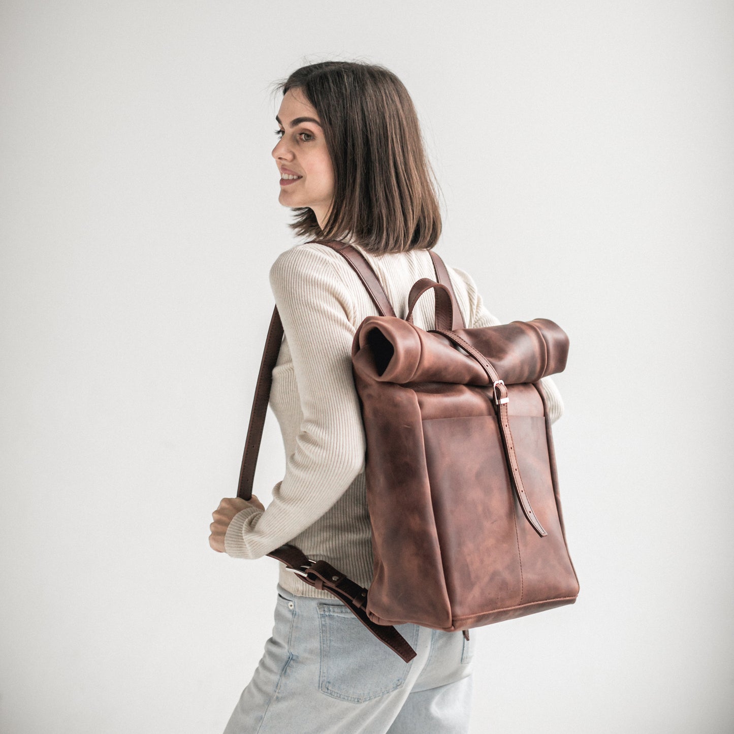 Whiskey brown leather roll-top backpack