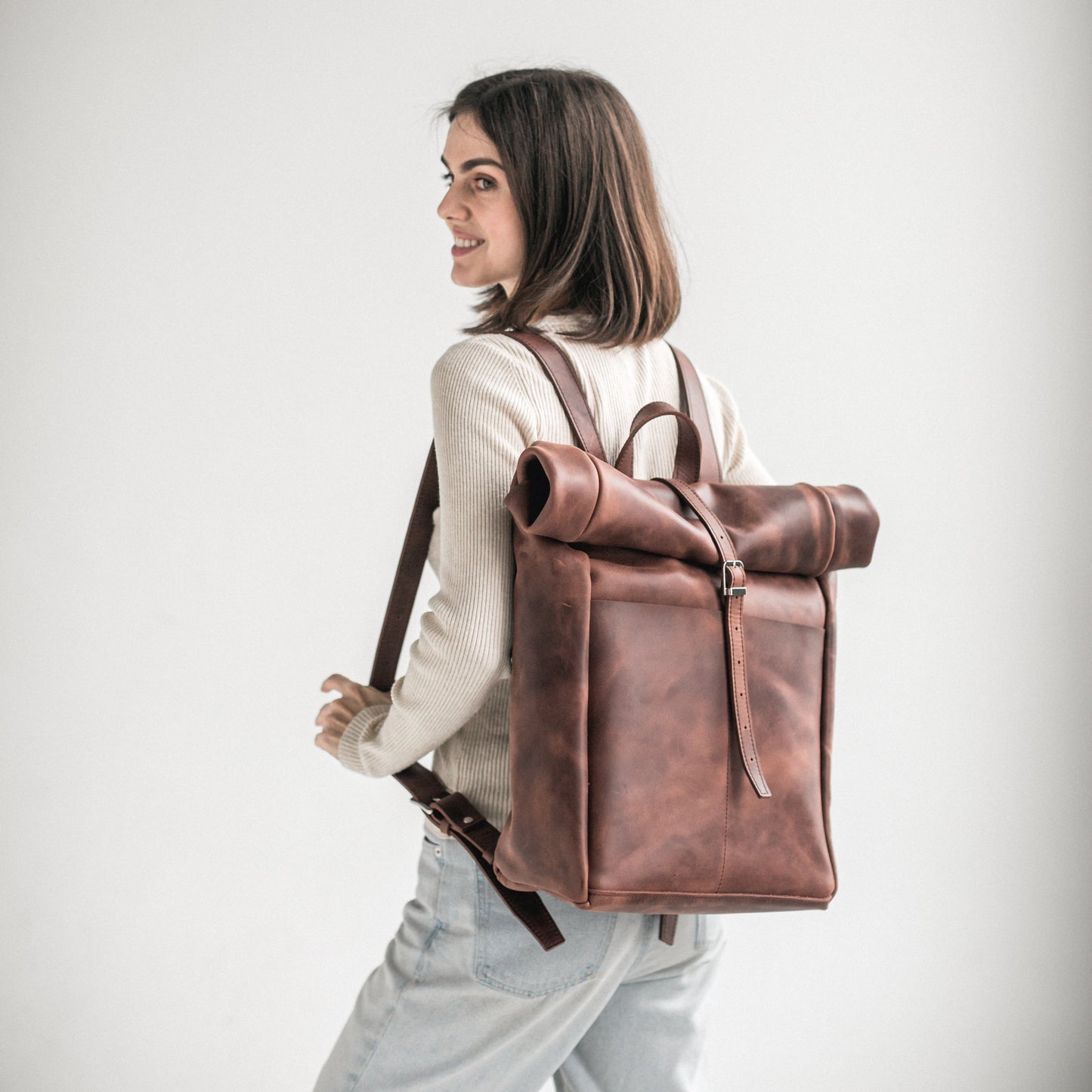 Whiskey brown leather roll-top backpack