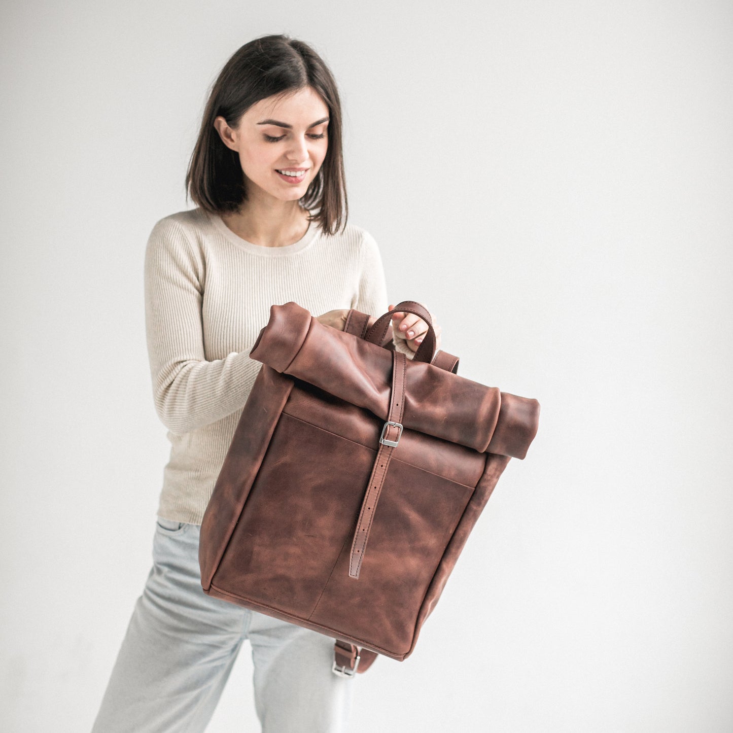 Whiskey brown leather roll-top backpack