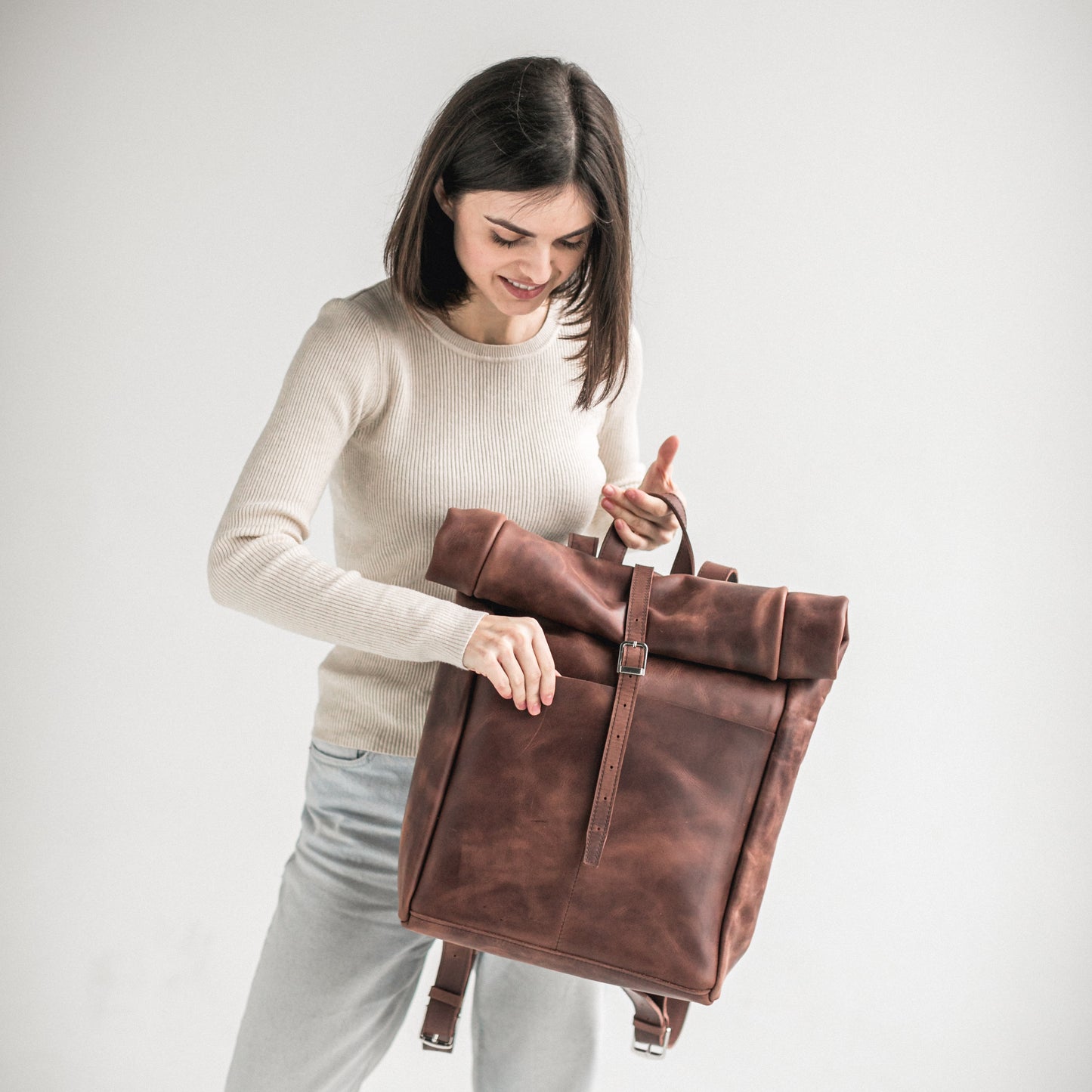 Whiskey brown leather roll-top backpack