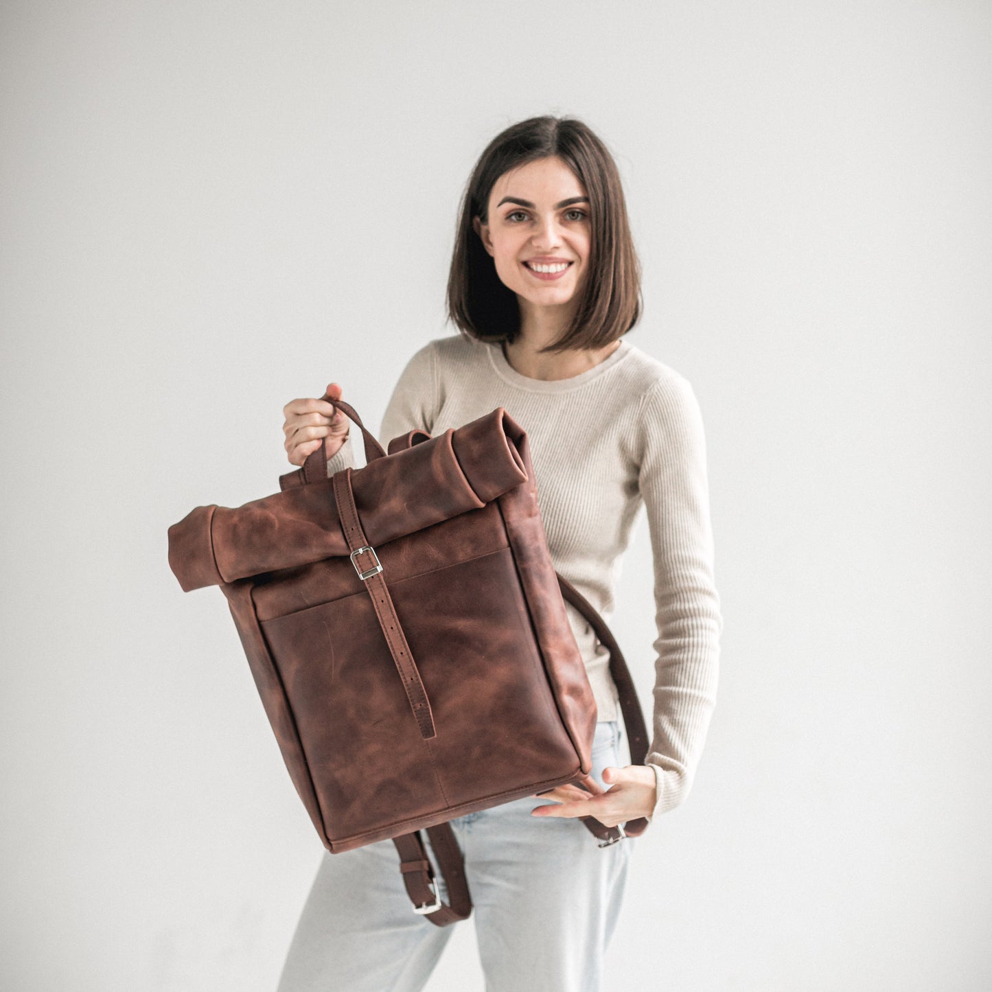 Whiskey brown leather roll-top backpack