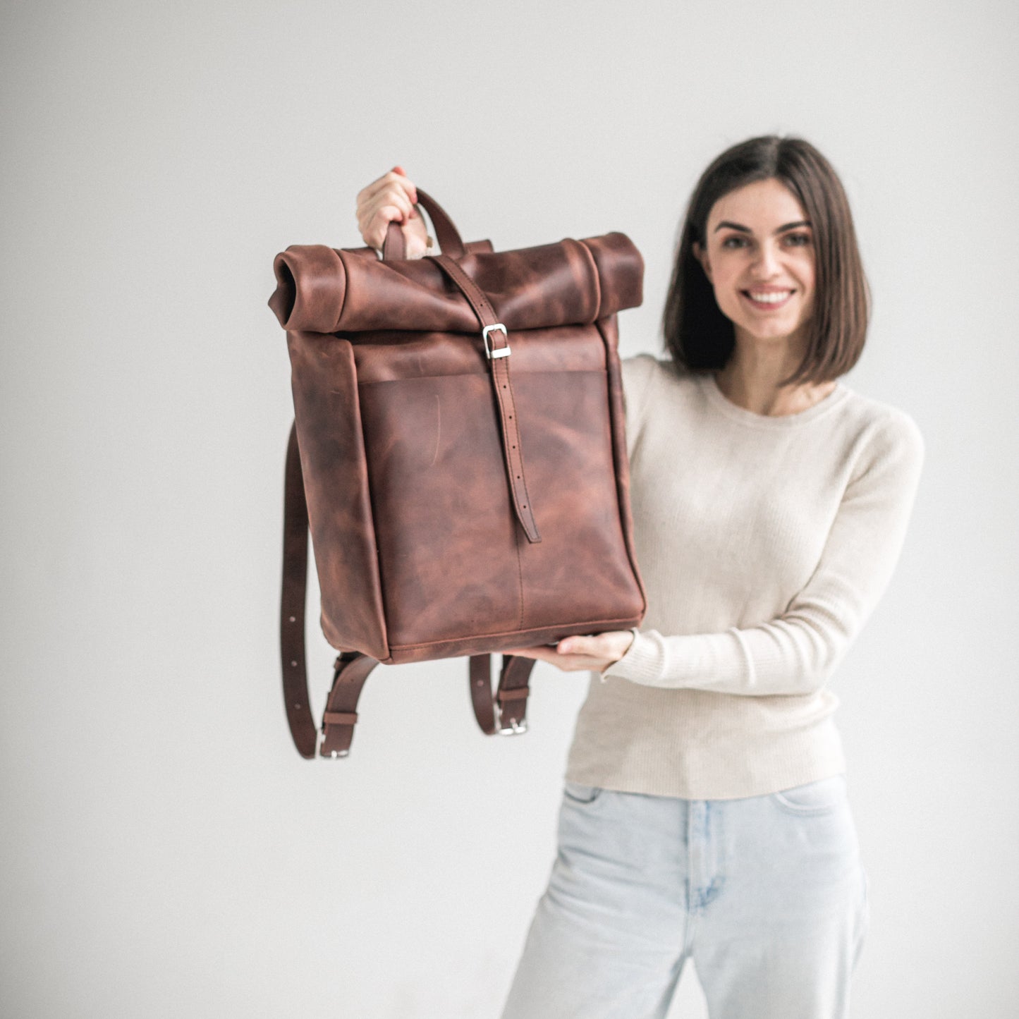 Whiskey brown leather roll-top backpack