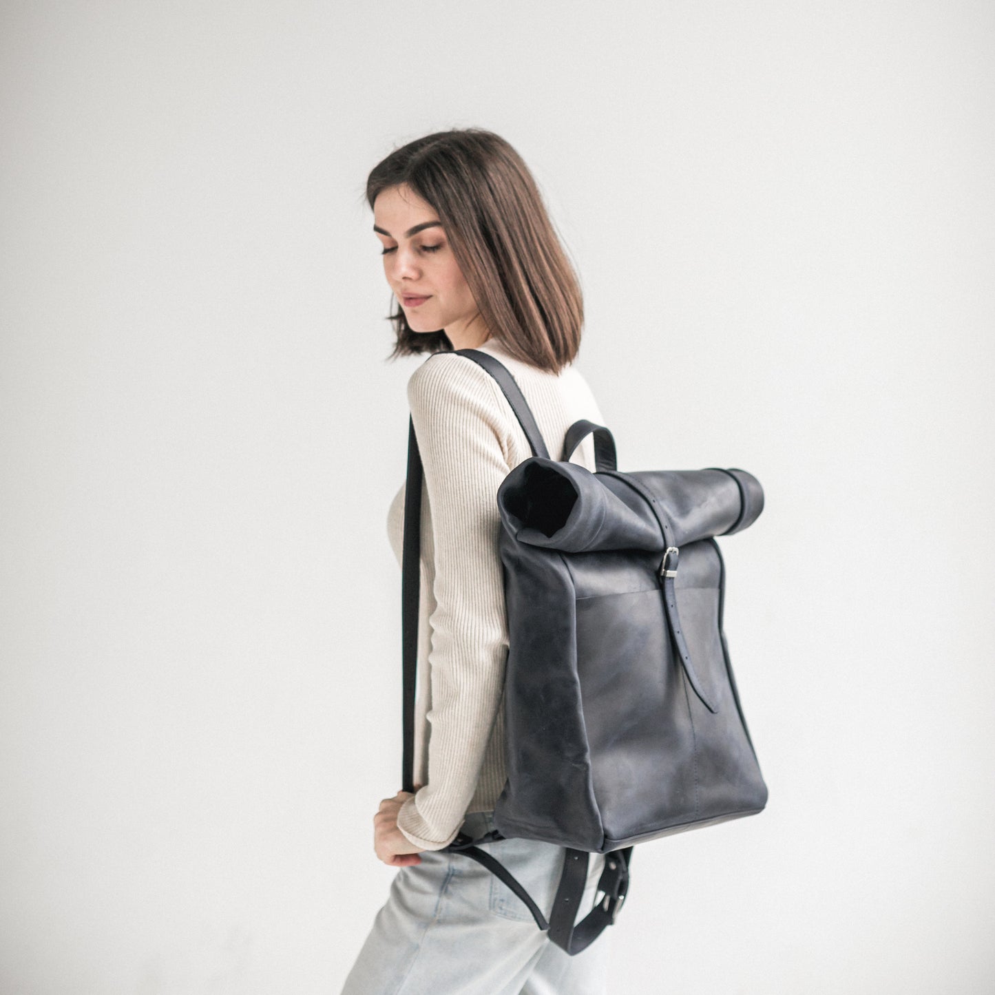 Navy blue leather roll-top backpack