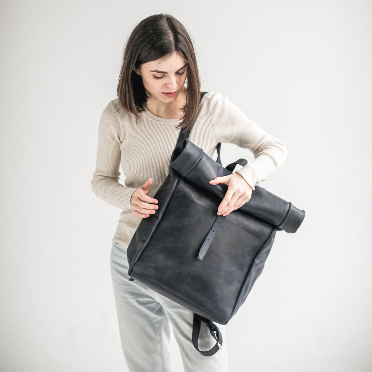 Navy blue leather roll-top backpack