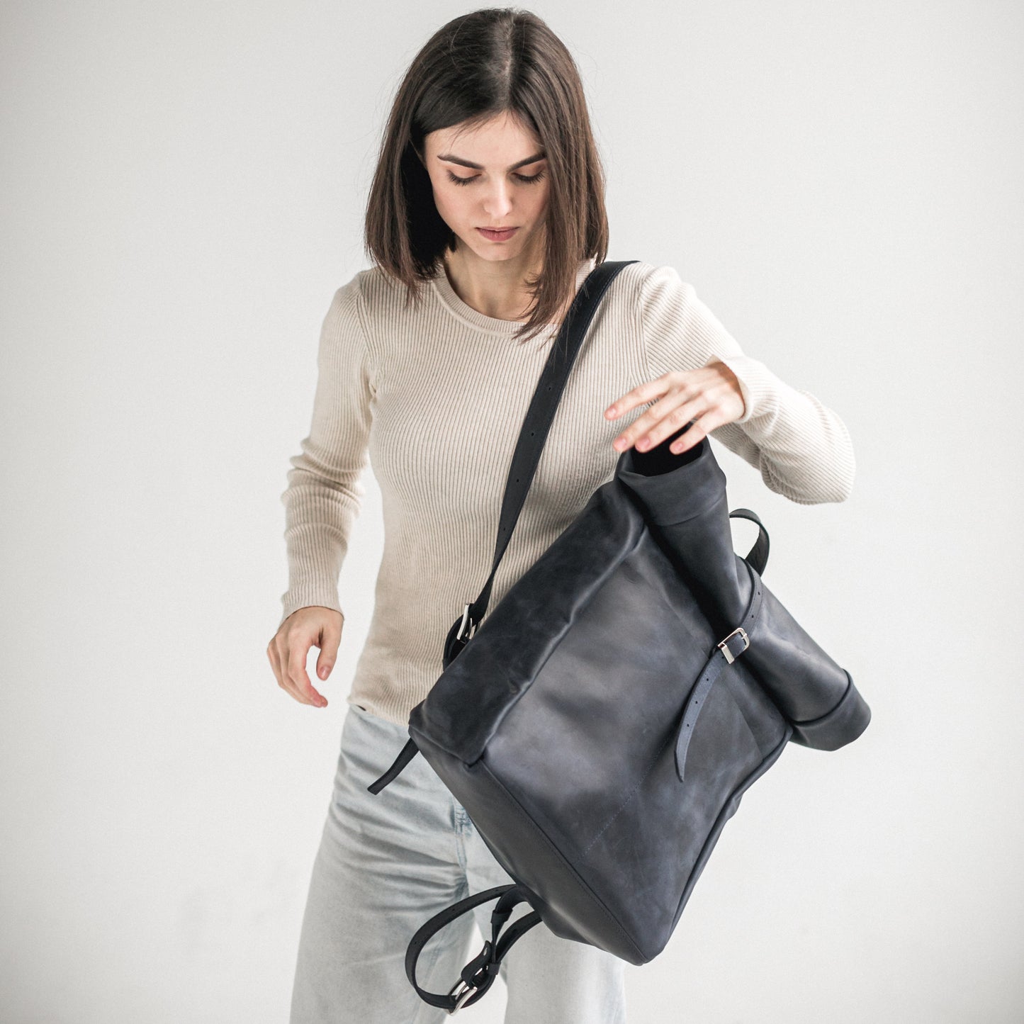 Navy blue leather roll-top backpack