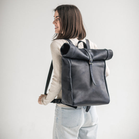 Navy blue leather roll-top backpack