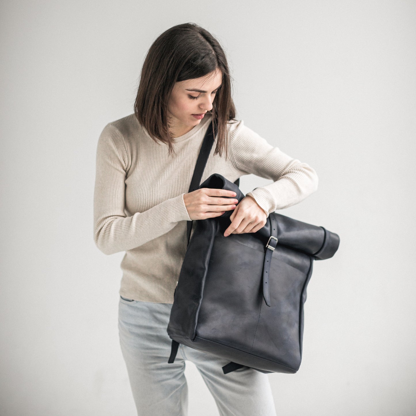 Navy blue leather roll-top backpack