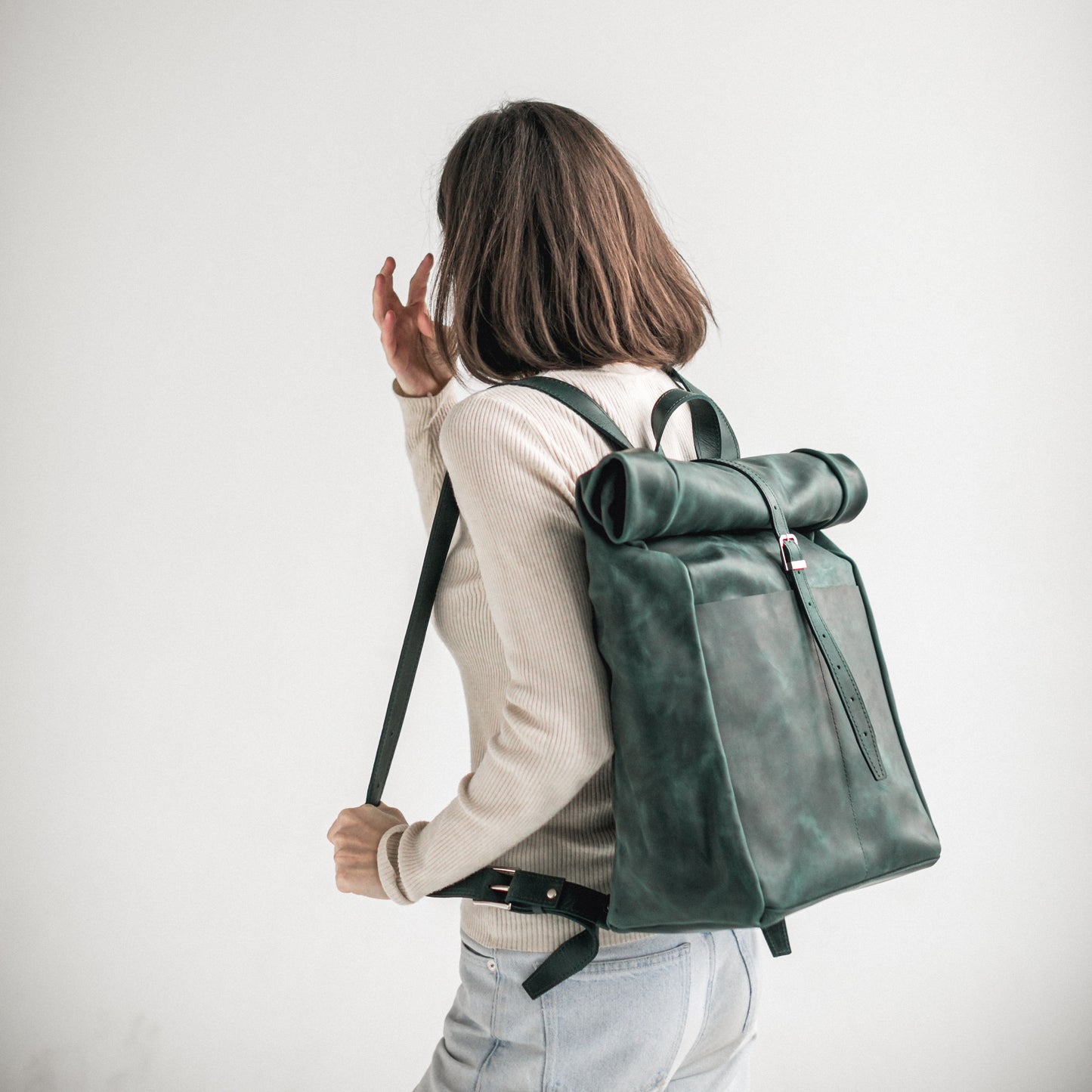 Green leather roll-top backpack