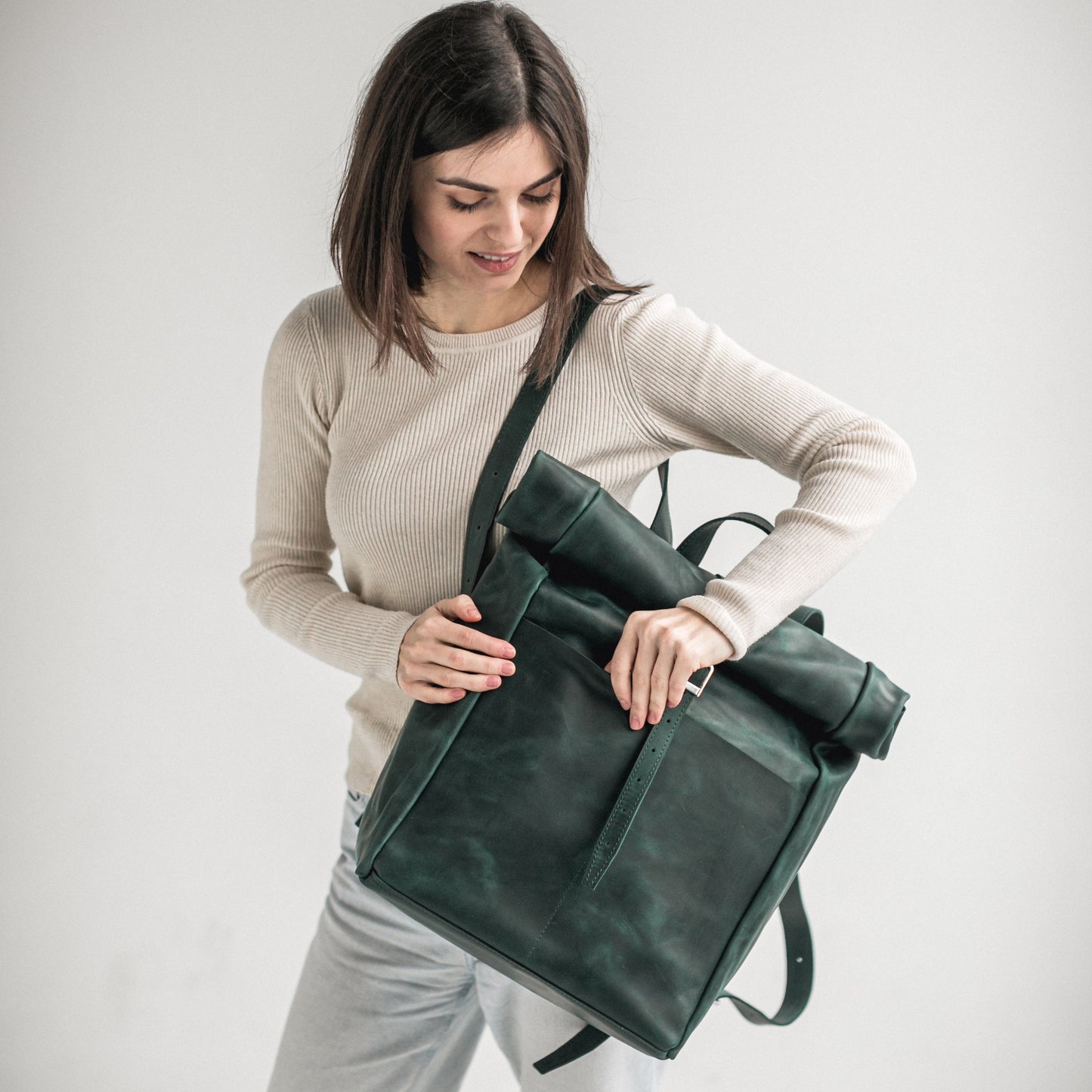 Green leather roll-top backpack