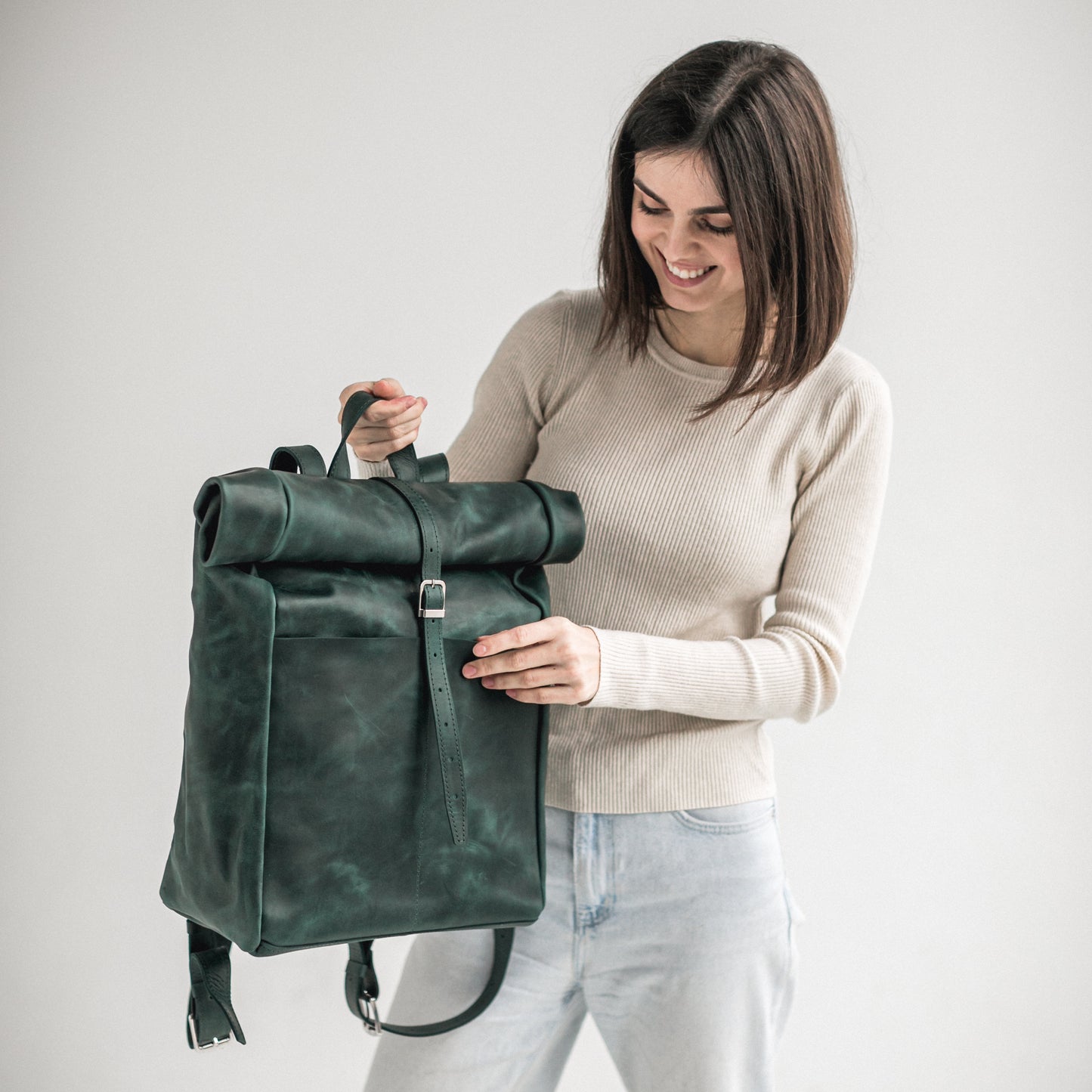 Green leather roll-top backpack