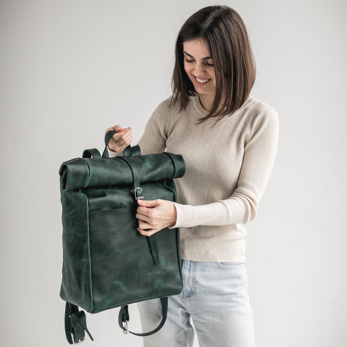 Green leather roll-top backpack