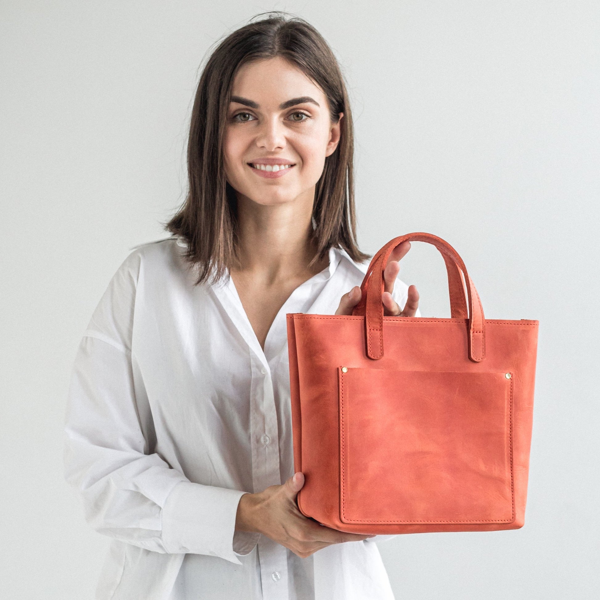 Orange leather mini tote bag with outside pocket 